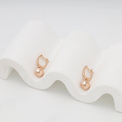 Rose gold ball earrings on sculptural display — 2005973101 — Kabluchka