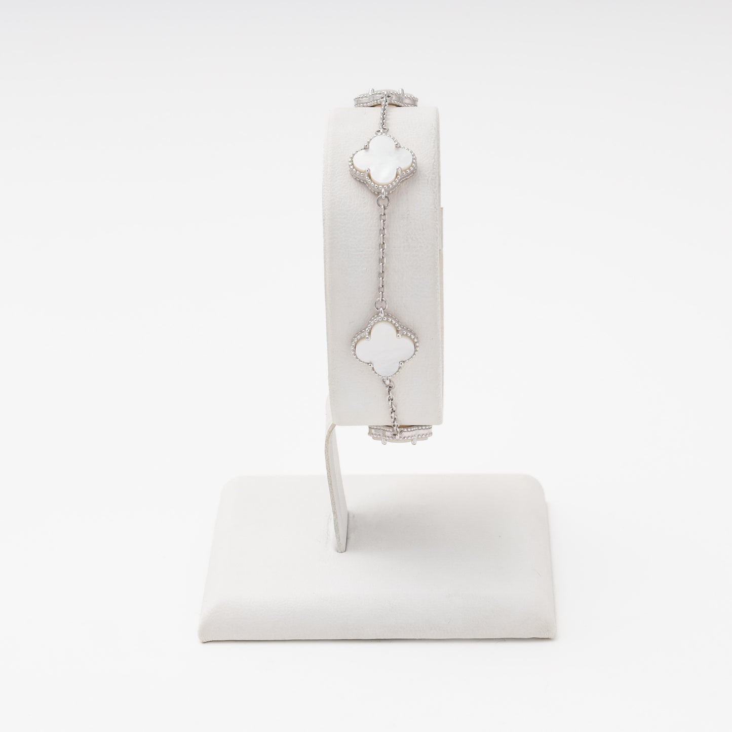 Silver bracelet with 4 mother-of-pearl clover charms on wrist stand — Kabluchka