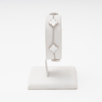 Silver bracelet with 4 mother-of-pearl clover charms on wrist stand — Kabluchka