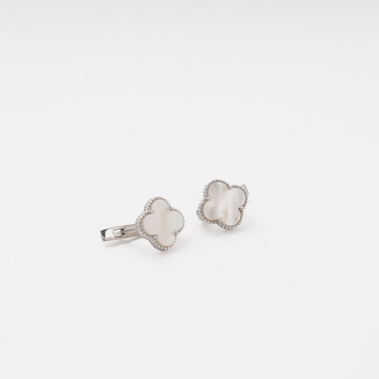 Silver mother-of-pearl earrings overhead view — Kabluchka