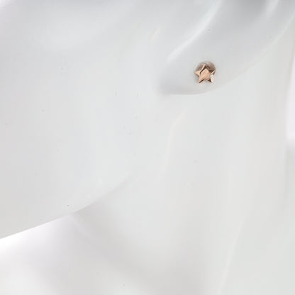 Close-up of a star-shaped earring on a white background