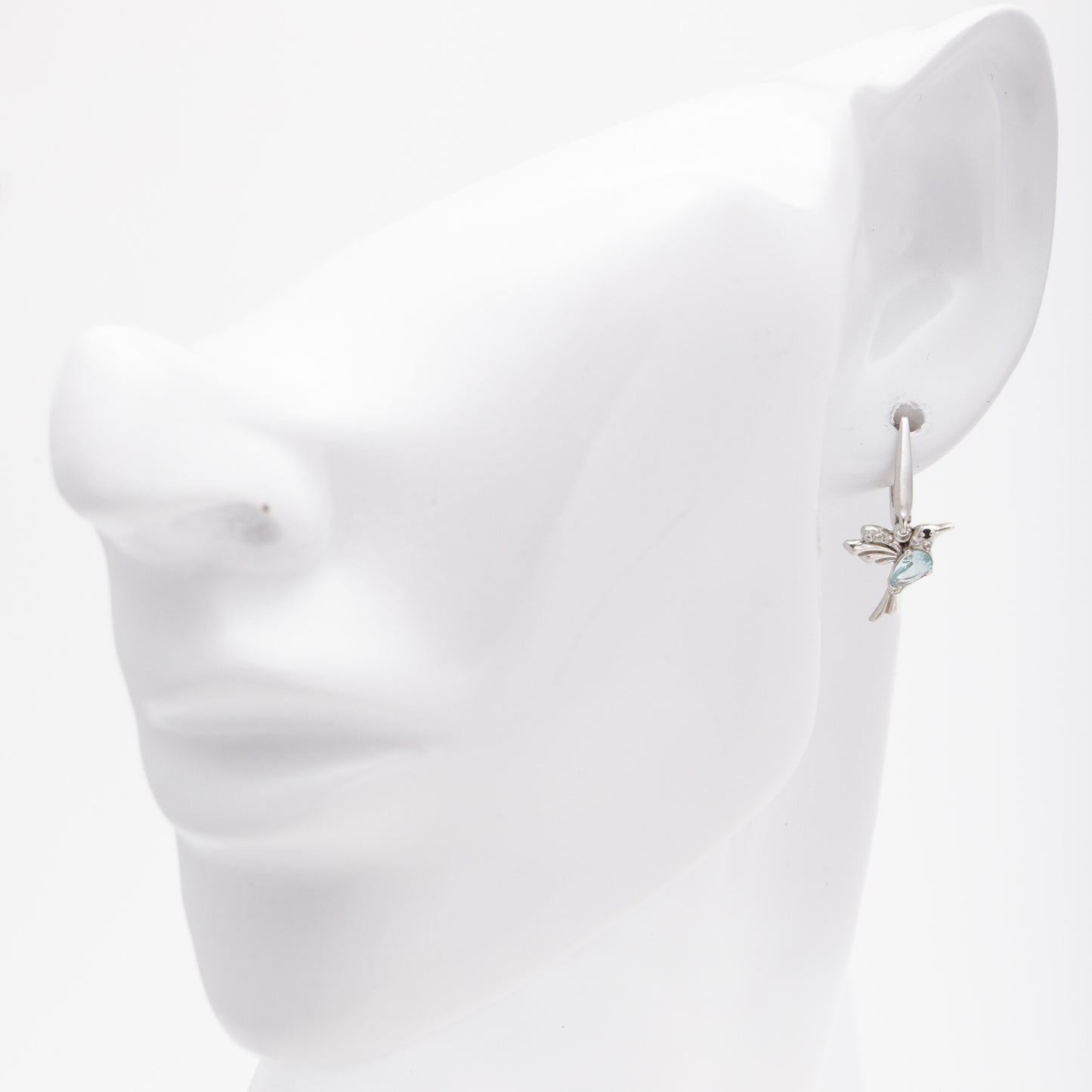 Silver 925 hummingbird earrings shown on ear model — Kabluchka