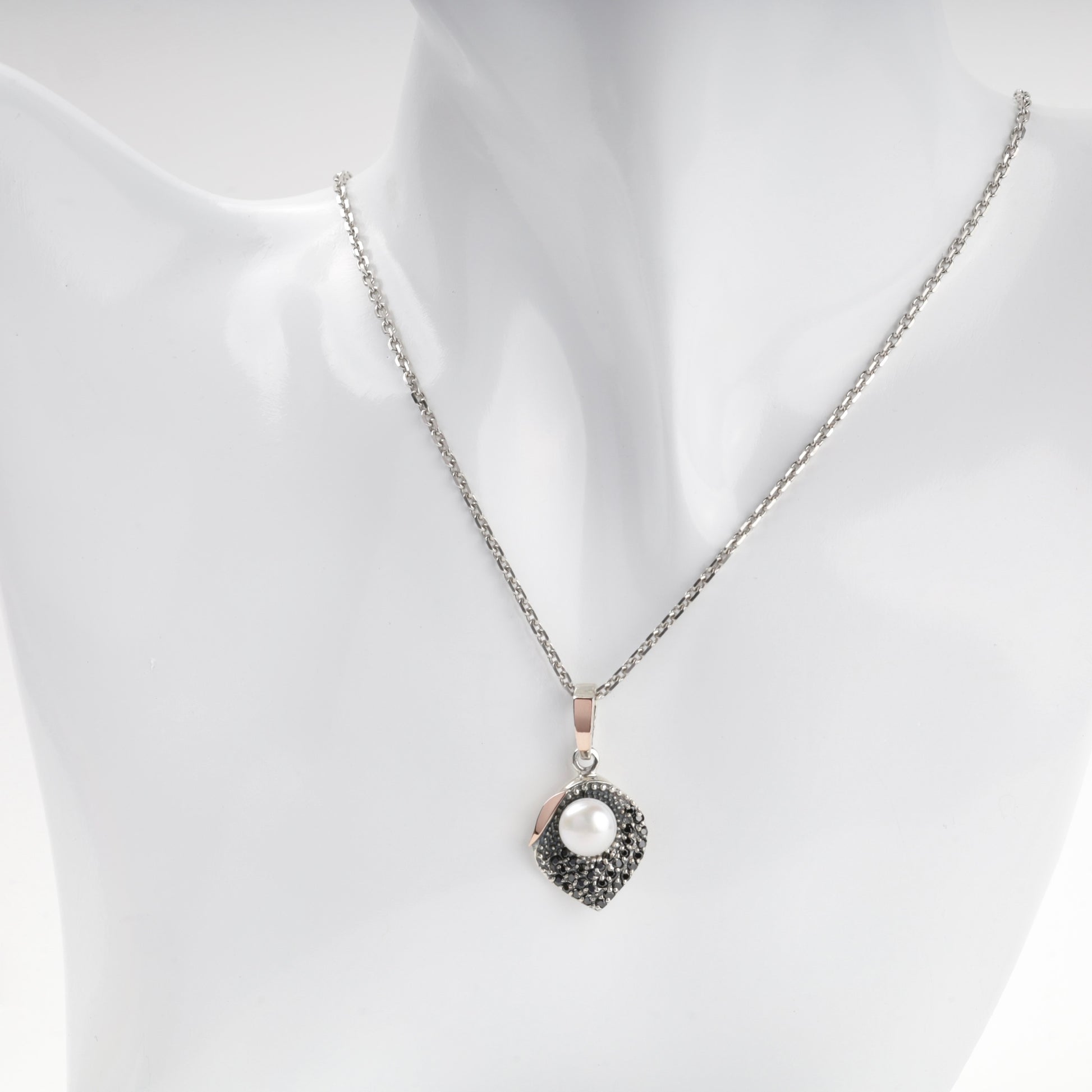 Pearl and dark cubic zirconia pendant shown on chain — Kabluchka