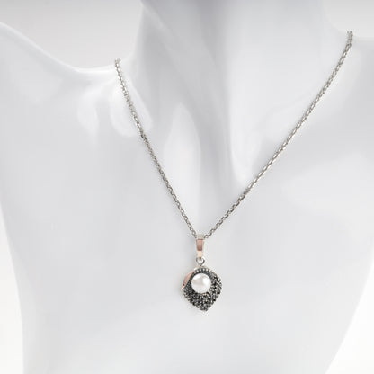 Pearl and dark cubic zirconia pendant shown on chain — Kabluchka