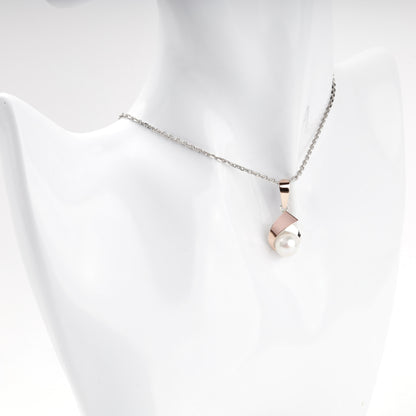 Cultured pearl pendant with warm rose-tone detail — worn view — Kabluchka