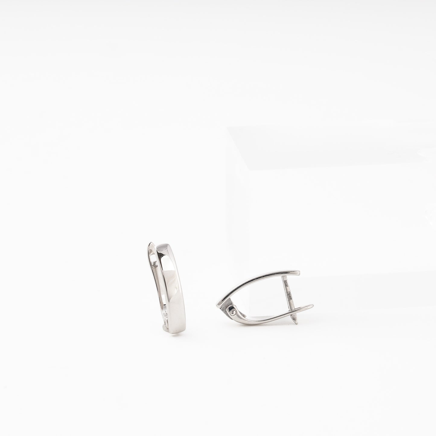 Silver 925 Oval Hoop Earrings on Surface — Kabluchka
