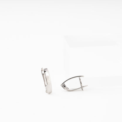 Silver 925 Oval Hoop Earrings on Surface — Kabluchka