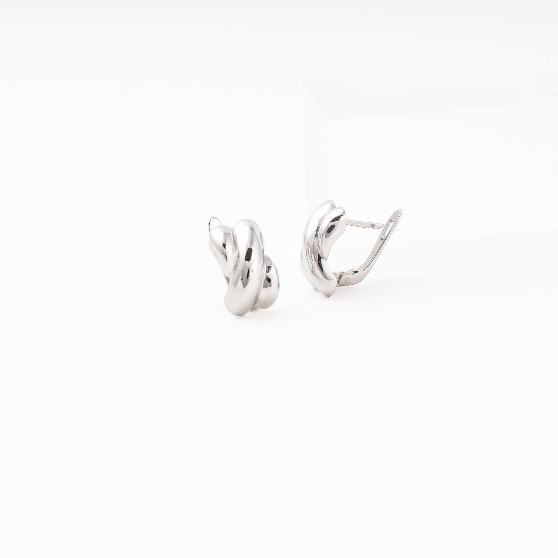 Silver 925 Chunky Oval Hoop Earrings on Surface — Kabluchka