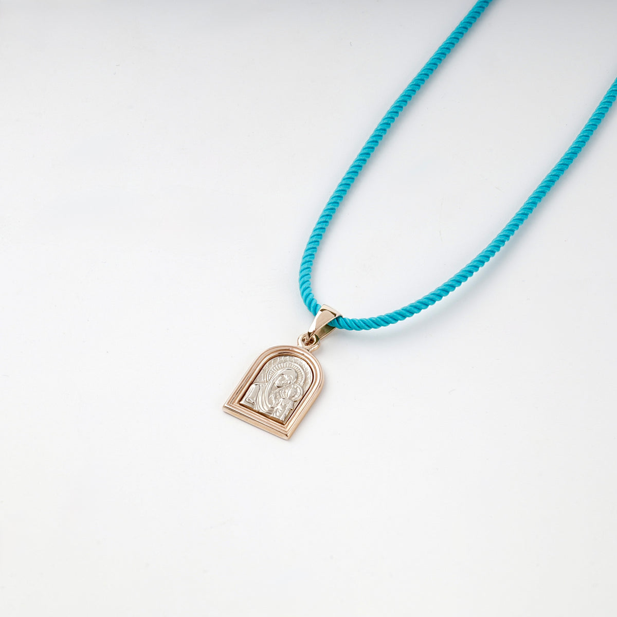 Rose and white gold Virgin Mary icon pendant, angled view