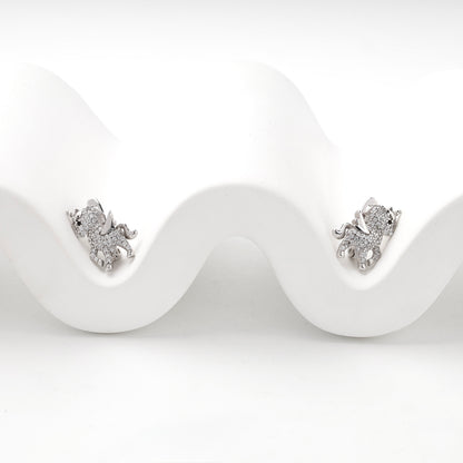 Silver unicorn earrings displayed on a white wave
