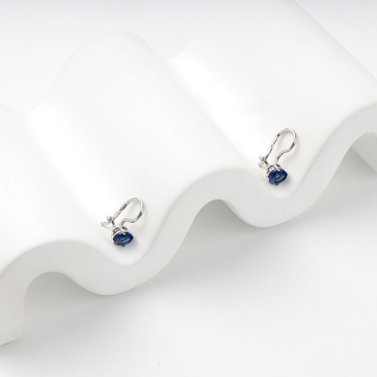 Lightweight silver hook earrings with round blue stones