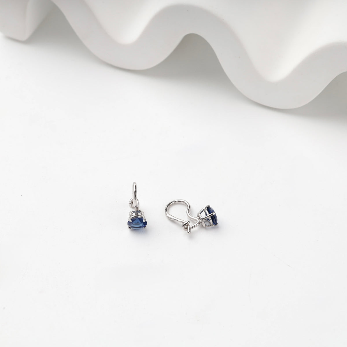 Silver hook earrings showing open prong settings