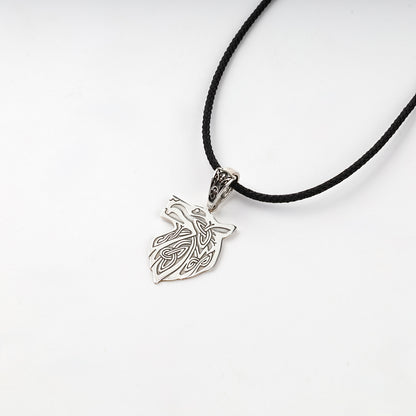 Silver wolf pendant with a decorative bail and dark recessed details