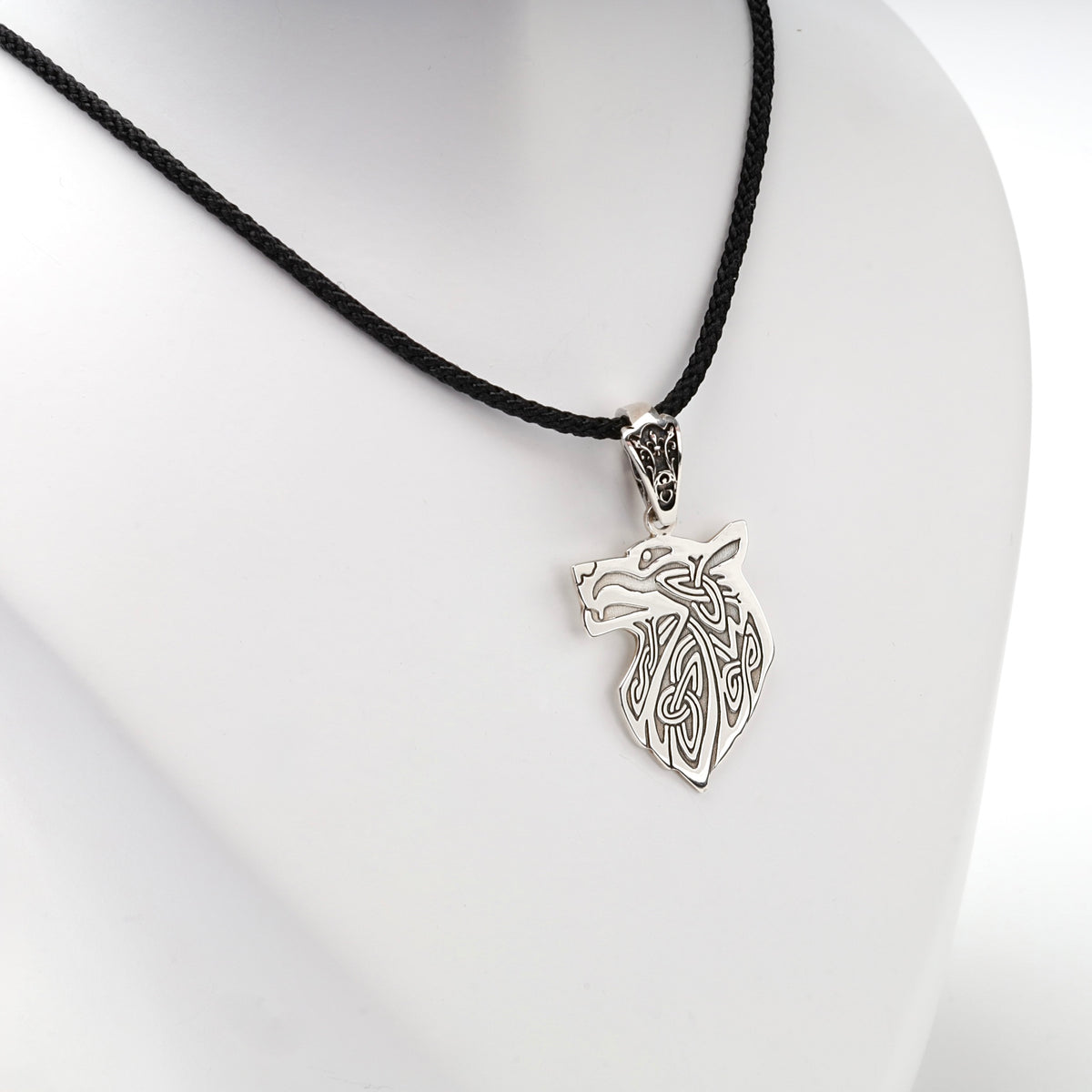 Openwork wolf head pendant with interlaced details, close view