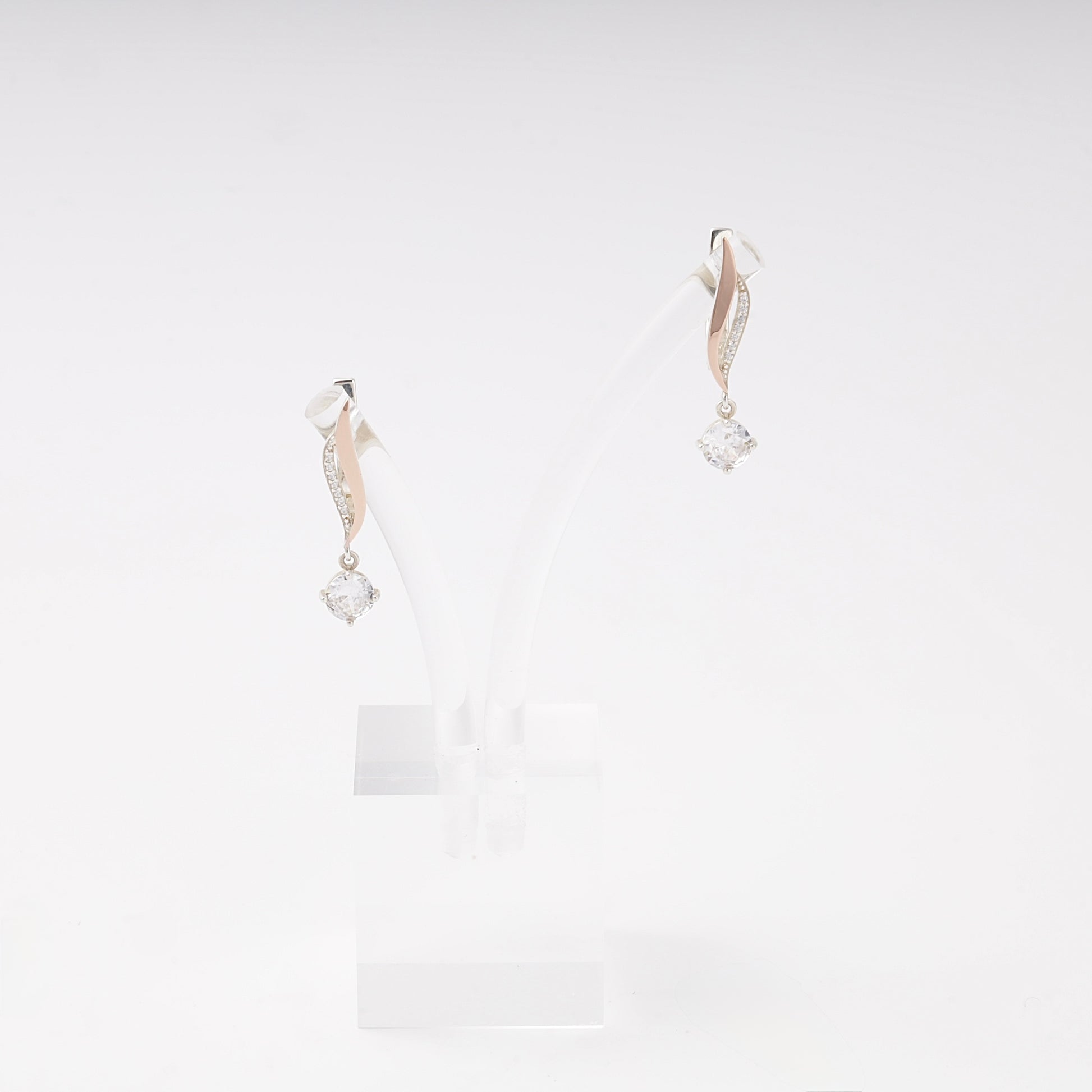 Silver 925 cubic zirconia twist drop earrings on a stand — Kabluchka