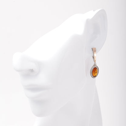 Silver 925 amber drop earring shown on ear model — Kabluchka