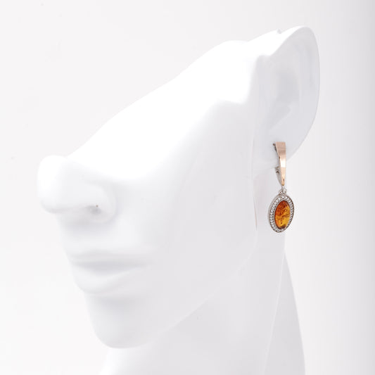 Silver 925 amber drop earring shown on ear model — Kabluchka