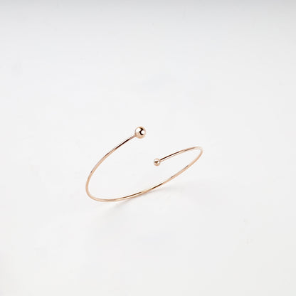 Rose Gold 14K asymmetric ball open bangle bracelet front view