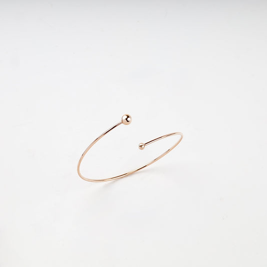 Rose Gold 14K asymmetric ball open bangle bracelet front view