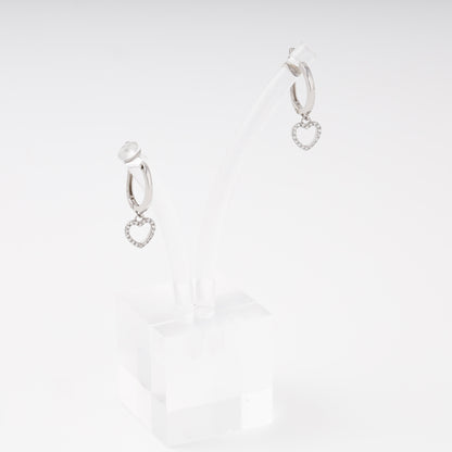 Silver drop earrings with open heart charm and cubic zirconia on display stand, side view — Kabluchka