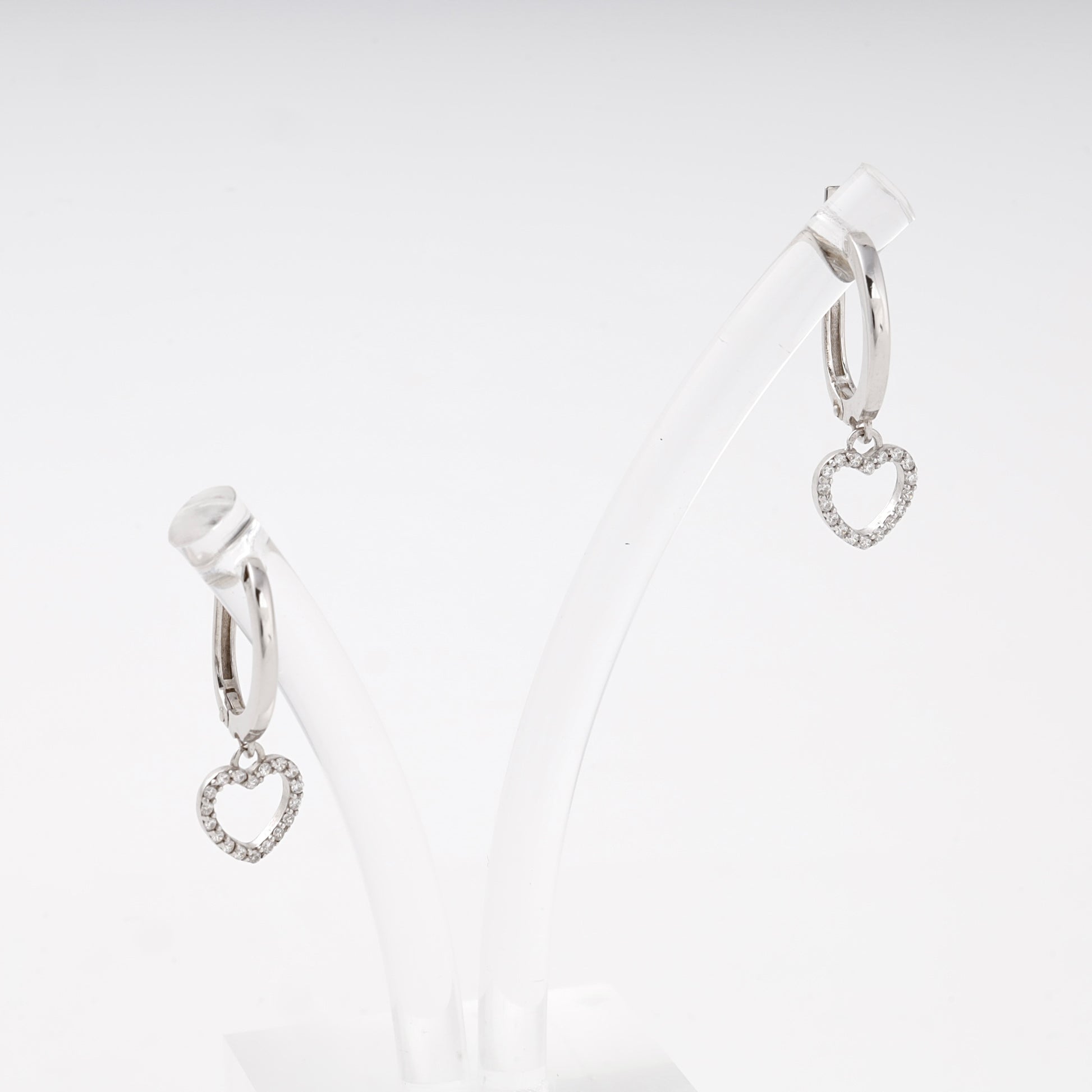 Silver drop earrings with CZ heart charm on display stand, close-up showing English lock — Kabluchka