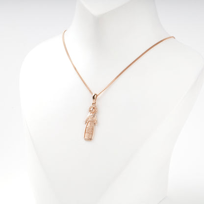 Rose Gold 14K motanka pendant with raised ornament, angled view