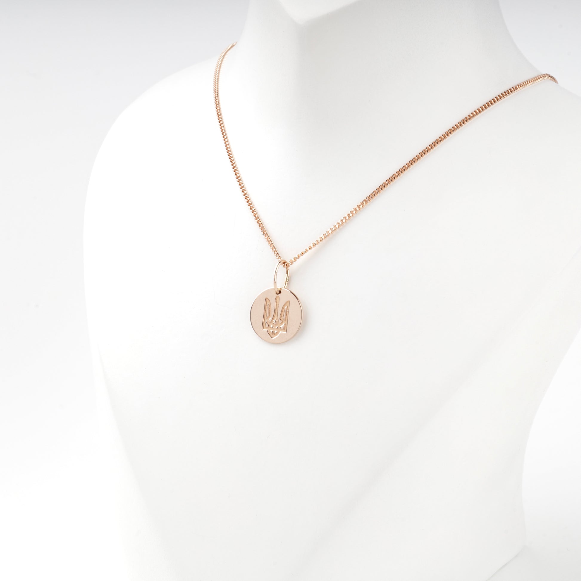 Raised Ukrainian Trident on a polished rose gold disc pendant