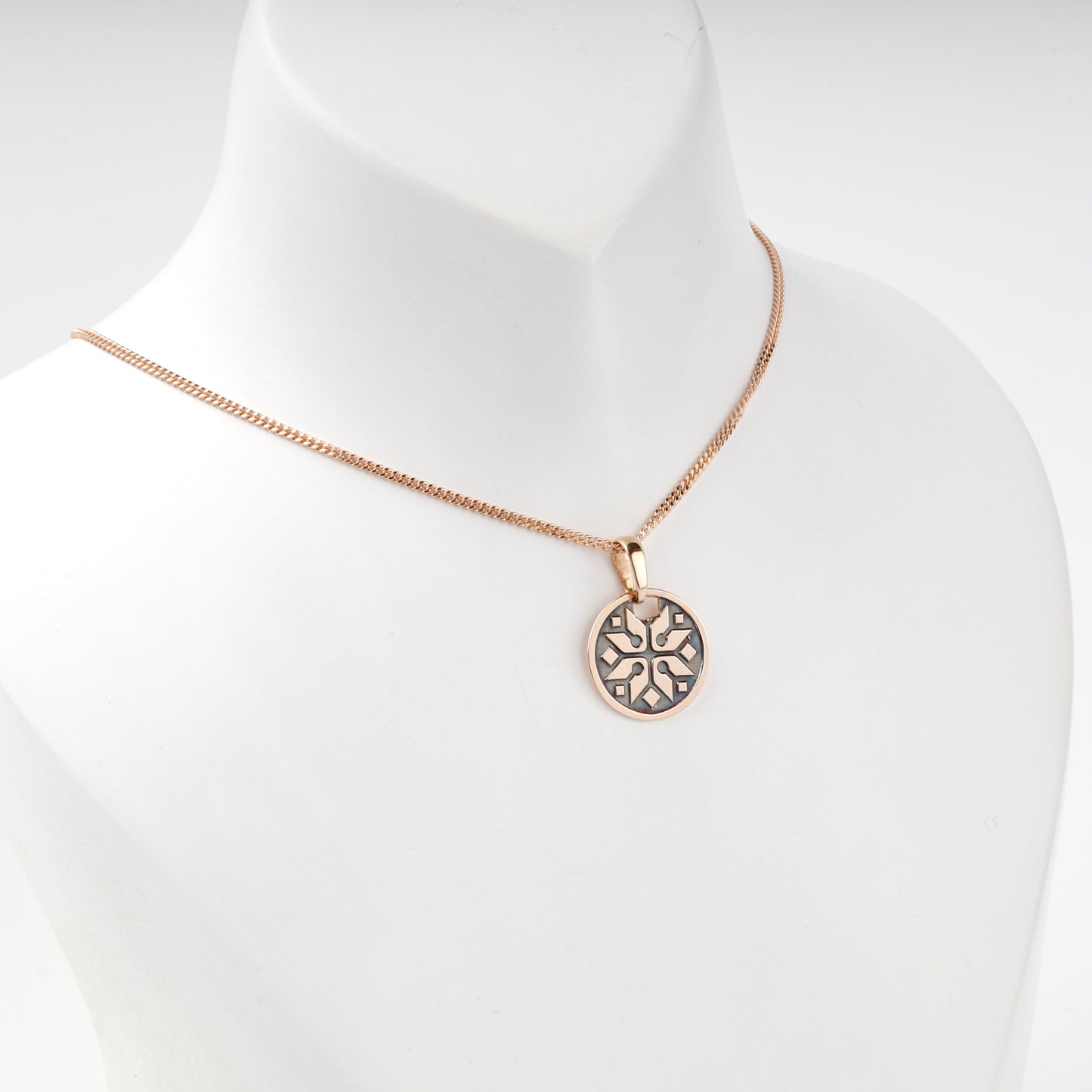 Rose Gold 14K eight-rayed ornamental pendant, angled view