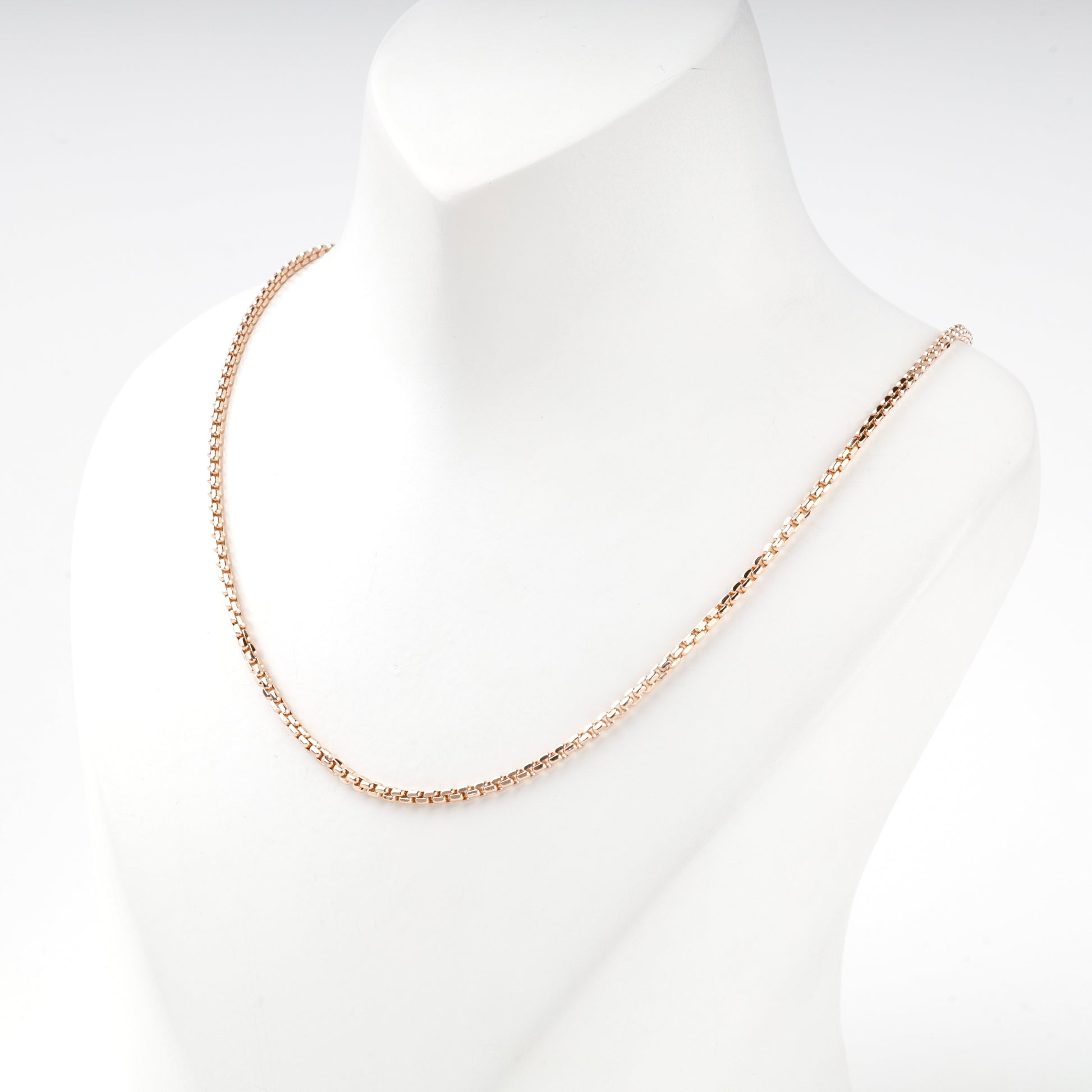 Compact squared links on a rose gold box chain, close view