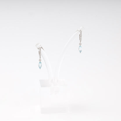 Silver 925 huggie earrings with blue topaz drop on display — Kabluchka