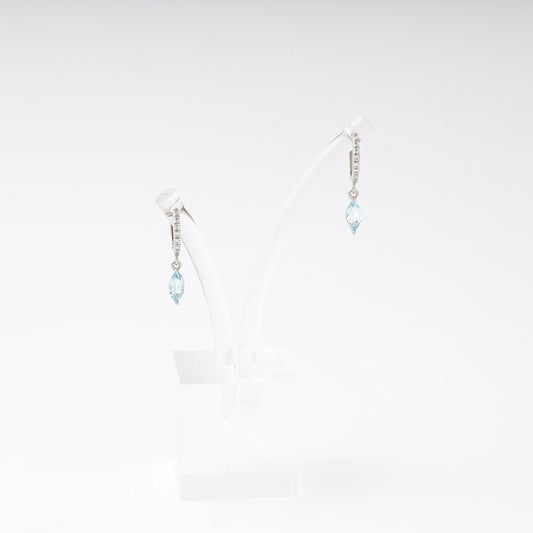 Silver 925 huggie earrings with blue topaz drop on display — Kabluchka
