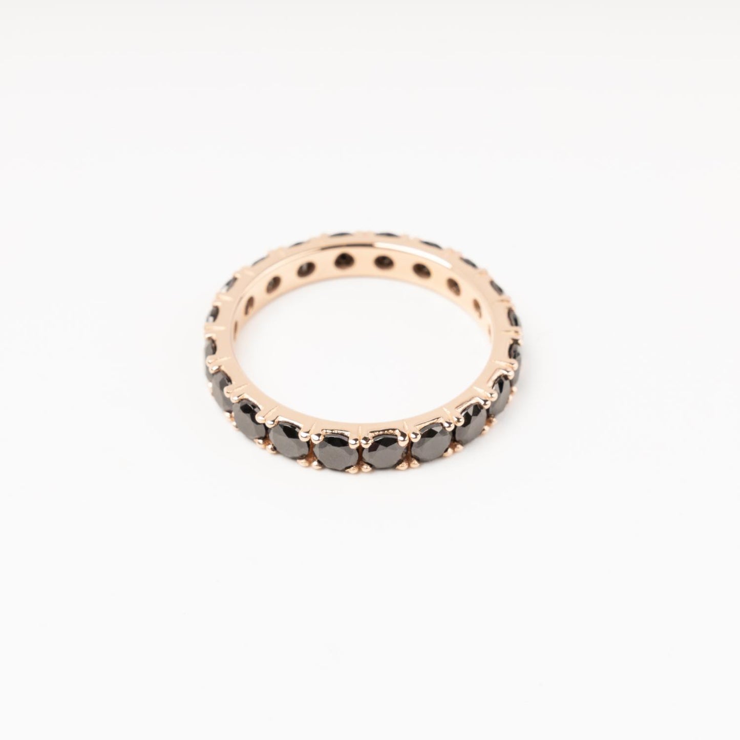 Sophisticated 14K (585) Rose Gold eternity ring encrusted with a continuous circle of sparkling black zirconias, displayed on a clean white background.