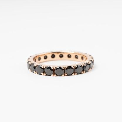 Sophisticated 14K (585) Rose Gold eternity ring encrusted with a continuous circle of sparkling black zirconias, displayed on a clean white background.