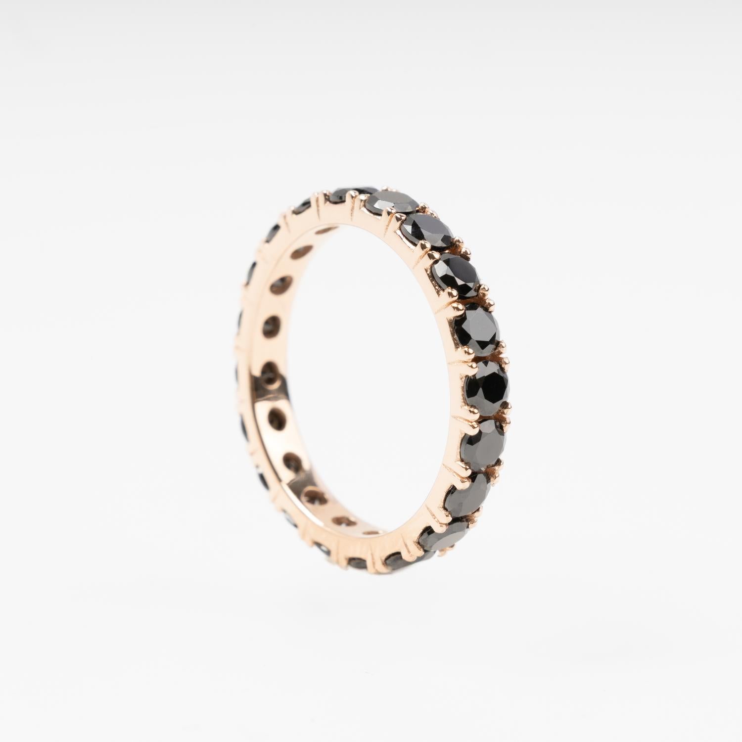 Sophisticated 14K (585) Rose Gold eternity ring encrusted with a continuous circle of sparkling black zirconias, displayed on a clean white background.