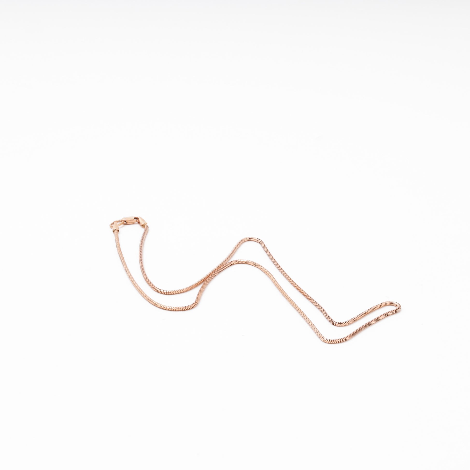 Rose gold snake chain laid flat — Kabluchka