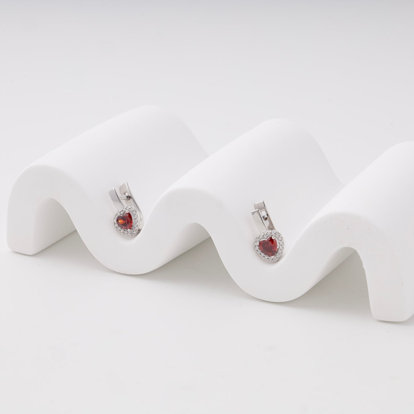 Silver 925 red heart cubic zirconia halo earrings, angled view — Kabluchka