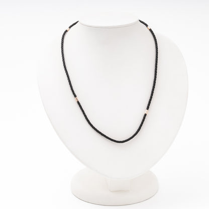 Black braided silk cord necklace with 14K rose gold fittings on bust — Kabluchka