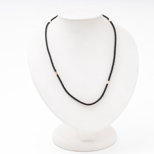 Black braided silk cord necklace with 14K rose gold fittings on bust — Kabluchka