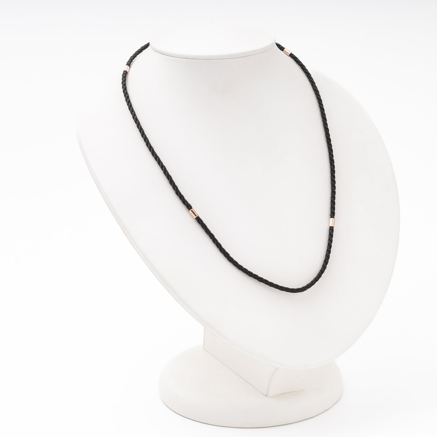 Rose gold cord necklace detail — cylindrical gold separators on black silk — Kabluchka