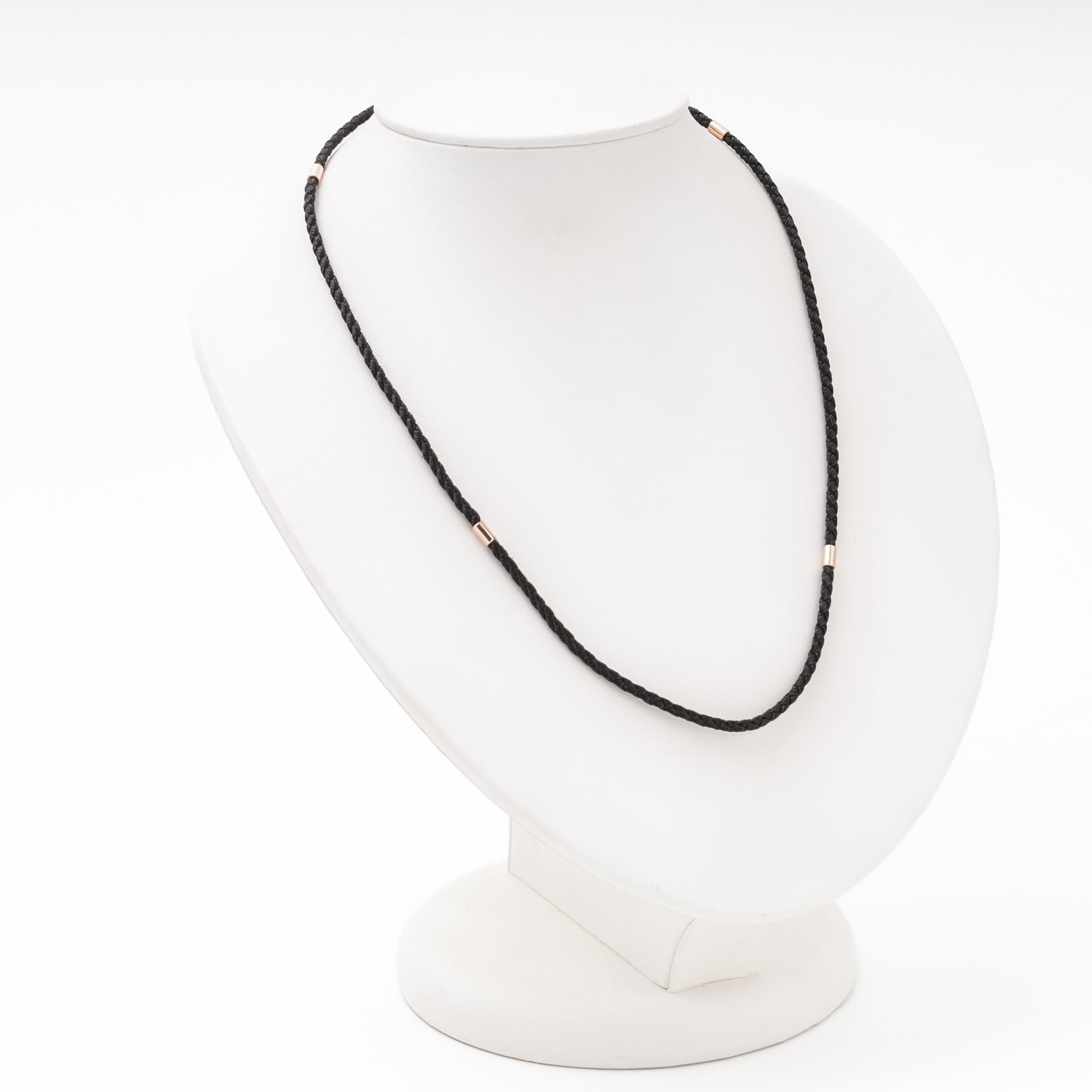 Rose gold cord necklace detail — cylindrical gold separators on black silk — Kabluchka