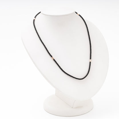 Rose gold cord necklace detail — cylindrical gold separators on black silk — Kabluchka