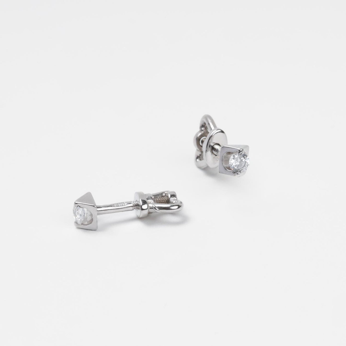 Technical close-up of 14K (585) White Gold stud earrings showing the high-security threaded screw-back post and the smooth white circular inlay.