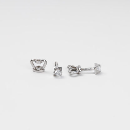 14K (585) White Gold geometric stud earrings and their corresponding screw-on locks displayed on a textured white surface, highlighting the brilliant metallic finish.