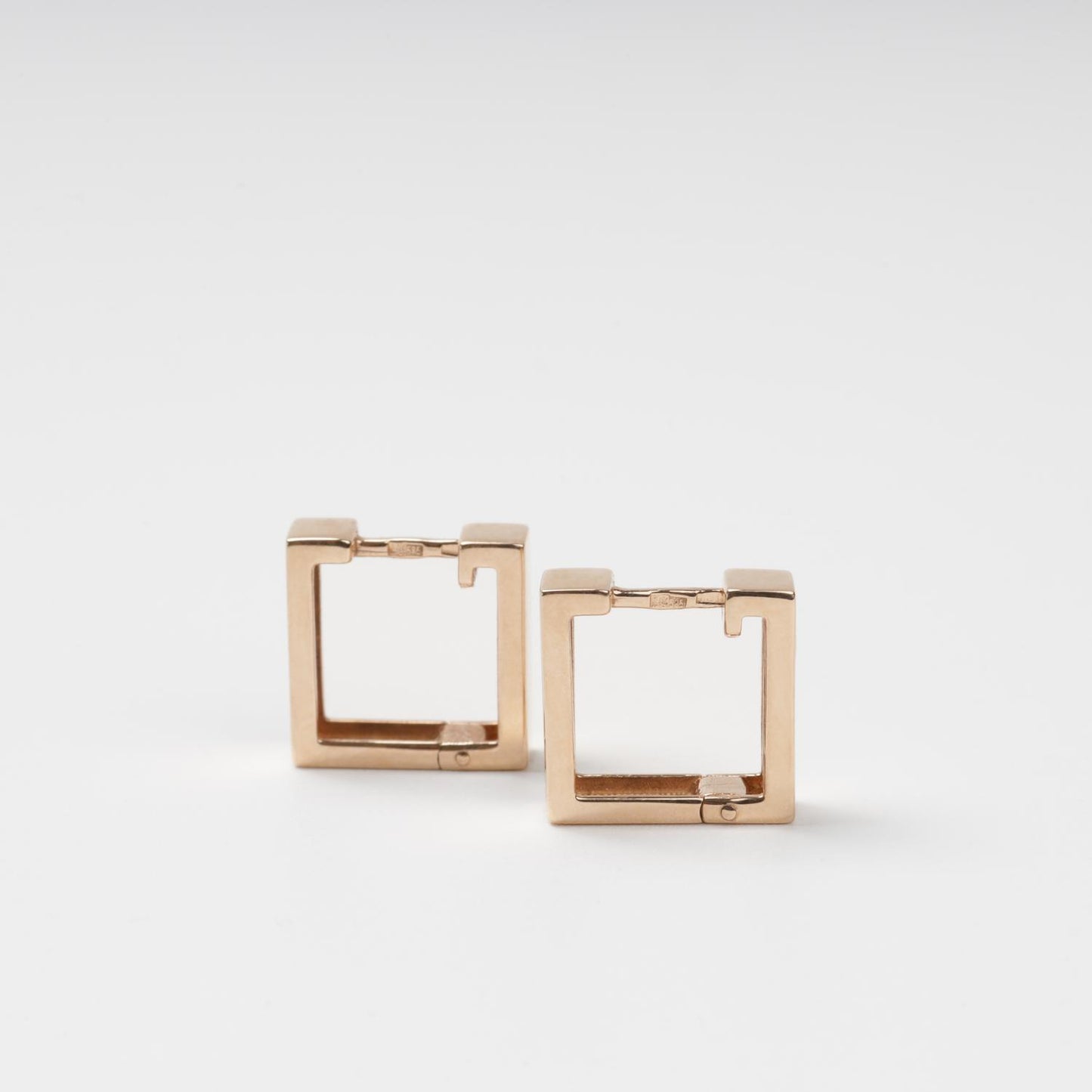 Symmetrical frontal view of minimalist 14K (585) Rose Gold square hoop earrings on a clean white background.