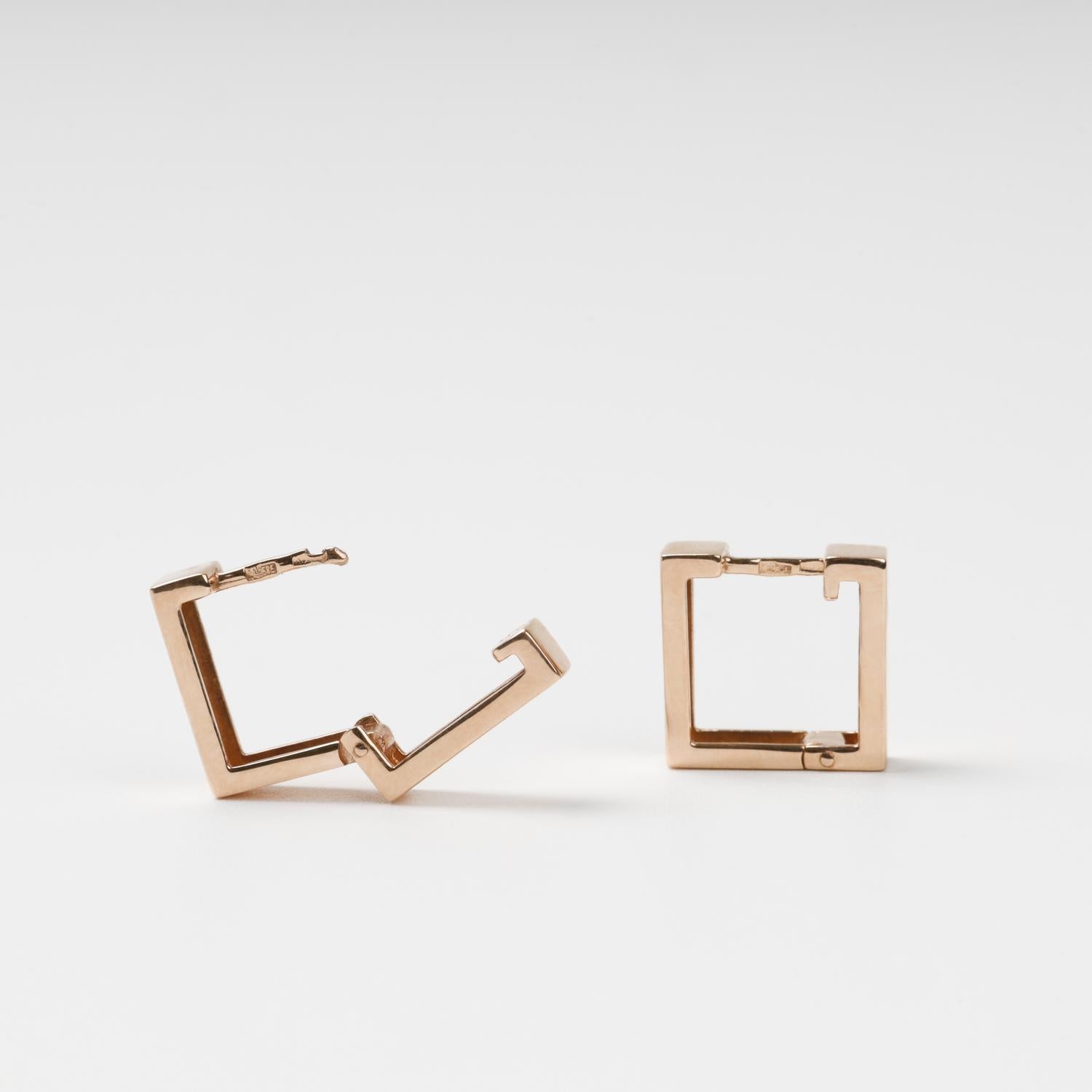 Detailed view of the hinged snap-lock mechanism and 585 hallmark on 14K rose gold square earrings.