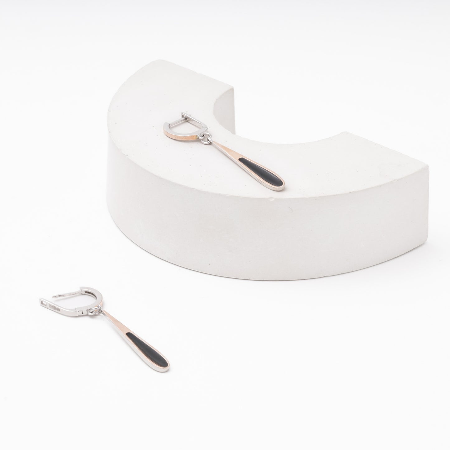 Silver drop earrings with black enamel — worn on ear — Kabluchka