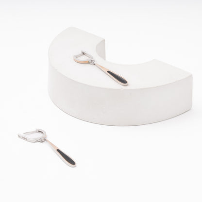 Silver drop earrings with black enamel — worn on ear — Kabluchka