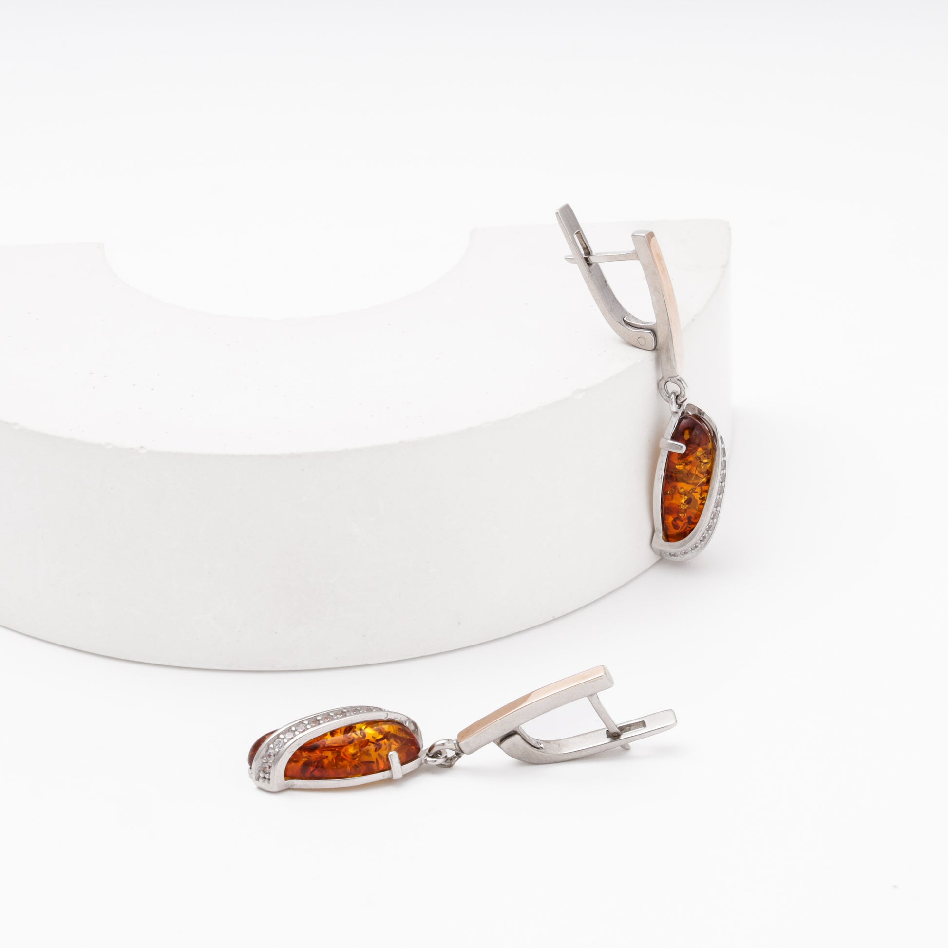 Silver drop earrings with amber and CZ on display — Kabluchka