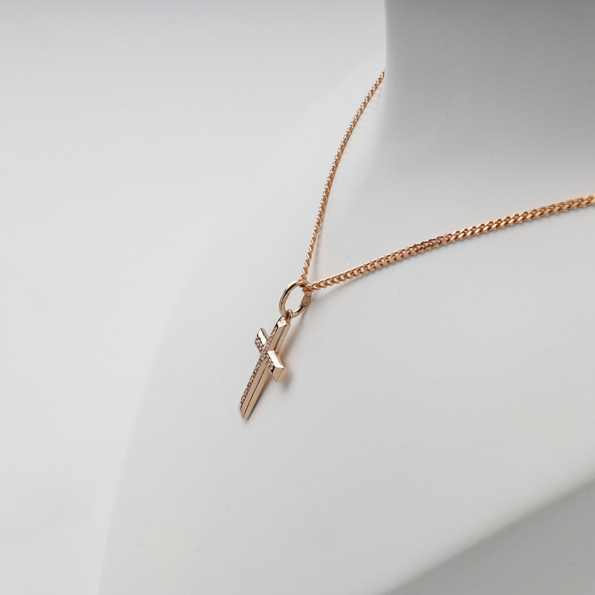 Side view of rose gold cubic zirconia cross pendant — Kabluchka