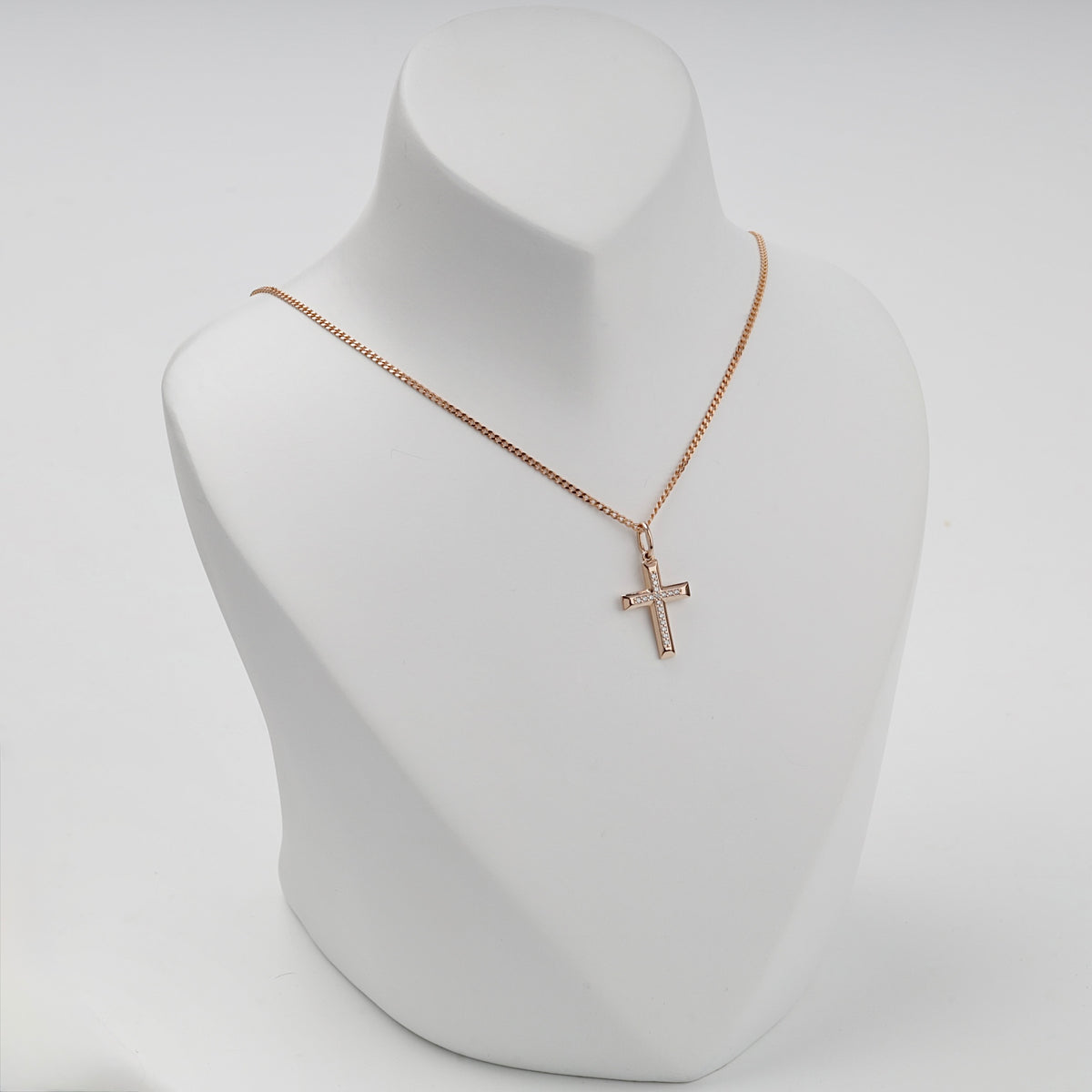 Rose gold cross pendant displayed on a necklace bust — Kabluchka